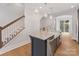 Kitchen island with granite countertop, stainless dishwasher, farmhouse sink, and stairway at 1409 Kenilworth Ave, Charlotte, NC 28203