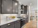 Well-lit kitchen with stainless steel oven, dark cabinets, and white tile backsplash at 1409 Kenilworth Ave, Charlotte, NC 28203