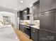 Modern kitchen featuring stainless steel appliances, dark wood cabinets, and tile backsplash at 1409 Kenilworth Ave, Charlotte, NC 28203
