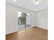 Bright and airy living room with sliding glass door, hardwood floors, and white walls at 1409 Kenilworth Ave, Charlotte, NC 28203