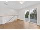 Bright living room featuring wood floors and sliding door to a deck at 1409 Kenilworth Ave, Charlotte, NC 28203