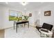 Bright office with black writing desk, comfortable chair, and a view into the adjacent bathroom at 1409 Kenilworth Ave, Charlotte, NC 28203