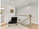 Cozy sitting area on the upper level with modern chair and access to a well-lit bathroom at 1409 Kenilworth Ave, Charlotte, NC 28203