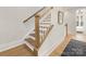 Stylish staircase featuring wooden steps and white railing leading to the upper level of the home at 1409 Kenilworth Ave, Charlotte, NC 28203