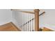Wood staircase with white banister posts and oak handrail at 1409 Kenilworth Ave, Charlotte, NC 28203