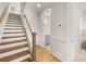 Elegant staircase with wood treads, white risers, and wooden handrail, leading to the upper level of the home at 1409 Kenilworth Ave, Charlotte, NC 28203