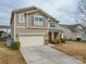 Charming two-story home featuring a two-car garage and welcoming front porch at 1411 Afternoon Sun Rd, Matthews, NC 28104