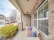 Inviting front porch with brick accents and a cozy bench with decorative pillows at 1411 Afternoon Sun Rd, Matthews, NC 28104