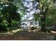 Charming single-story home with a white porch and mature trees surrounding the property at 1629 & 1631 Harris Rd # 6&7, Fort Mill, SC 29708
