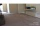 Open-concept living room with neutral carpet, view to kitchen and fireplace at 1629 & 1631 Harris Rd # 6&7, Fort Mill, SC 29708