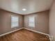 Bedroom with hardwood flooring and dual windows providing natural light at 176 Gravel Hill Ct, Taylorsville, NC 28681