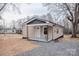 Exterior view of a house featuring light beige siding and a charming covered front porch at 176 Gravel Hill Ct, Taylorsville, NC 28681