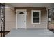 Inviting front entrance with a white door, decorative window, and modern wall-mounted sconces at 176 Gravel Hill Ct, Taylorsville, NC 28681