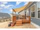 Wooden deck with shade covering and lights offers an inviting outdoor living space, complemented by the home's exterior at 19011 Dry Narrows Way, Charlotte, NC 28278