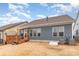Backyard view featuring a wooden deck with shade, siding exterior, and a well-maintained yard at 19011 Dry Narrows Way, Charlotte, NC 28278