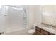 Bathroom featuring granite countertops, wood cabinets, ceramic tile floor, tub and bright window at 19011 Dry Narrows Way, Charlotte, NC 28278