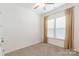 Bedroom with carpet floors, ceiling fan, tan curtains, and a bright window at 19011 Dry Narrows Way, Charlotte, NC 28278