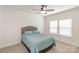 Bedroom with carpet floors, bed with blue comforter, ceiling fan and a bright window at 19011 Dry Narrows Way, Charlotte, NC 28278