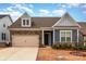 Charming two-story home with a two-car garage, stone accents, and manicured landscaping at 19011 Dry Narrows Way, Charlotte, NC 28278