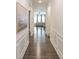 Hallway with beautiful hardwood floors and decorative wainscoting leading to the living area at 19011 Dry Narrows Way, Charlotte, NC 28278
