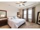 Cozy main bedroom featuring large windows and tray ceilings at 19011 Dry Narrows Way, Charlotte, NC 28278