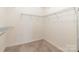 An organized walk-in closet that features carpeted floors and metal shelving at 19011 Dry Narrows Way, Charlotte, NC 28278