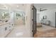 Bathroom featuring marble floors, double sink vanity, and a frameless glass shower at 2013 South St, Charlotte, NC 28208