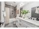 Modern bathroom with double sinks, tiled shower and tub combination, and stylish fixtures at 2013 South St, Charlotte, NC 28208