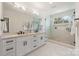 Bright bathroom featuring a double sink vanity and walk-in glass shower with marble tiling at 2013 South St, Charlotte, NC 28208