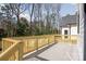 Outdoor wooden deck perfect for entertaining with a view of the backyard and mature trees at 2013 South St, Charlotte, NC 28208