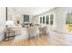 Bright living room with hardwood floors, fireplace, large windows, and neutral color palette at 2013 South St, Charlotte, NC 28208