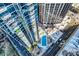 Aerial view of a rooftop pool with lounge chairs among tall condos in the city at 210 N Church St # 1507, Charlotte, NC 28202