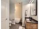 Modern bathroom with a soaking tub, black fixtures, and a wood vanity with a black countertop at 210 N Church St # 1507, Charlotte, NC 28202