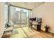 Bright bedroom with a desk, hardwood floors, and a large window with city views at 210 N Church St # 1507, Charlotte, NC 28202