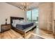 Modern bedroom with floor-to-ceiling windows and a city view, featuring a stylish light fixture at 210 N Church St # 1507, Charlotte, NC 28202