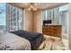 Bedroom showcasing city views from floor-to-ceiling windows, wood floors, and modern decor at 210 N Church St # 1507, Charlotte, NC 28202