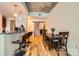 Bright dining area featuring a granite breakfast bar with pendant lights and a dark wood dining table with six chairs at 210 N Church St # 1507, Charlotte, NC 28202