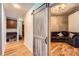 Hallway featuring a sliding barn door leading to a living space with a brown sectional sofa at 210 N Church St # 1507, Charlotte, NC 28202