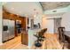 Bright kitchen and dining area with stainless steel appliances, breakfast bar with three stools, and a sliding barn door at 210 N Church St # 1507, Charlotte, NC 28202