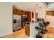 Modern kitchen with stainless steel appliances, dark wood cabinets, and a granite breakfast bar at 210 N Church St # 1507, Charlotte, NC 28202