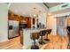 Bright kitchen and dining area with stainless steel appliances, breakfast bar with three stools, and a sliding barn door at 210 N Church St # 1507, Charlotte, NC 28202