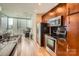 Bright modern kitchen with city views, stainless steel appliances, and dark wood cabinets at 210 N Church St # 1507, Charlotte, NC 28202