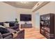 Comfortable living room with a flat-screen TV, a display cabinet, and a plush gray sectional sofa at 210 N Church St # 1507, Charlotte, NC 28202