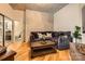 Comfortable living room featuring a plush sectional sofa, hardwood floors, and modern decor at 210 N Church St # 1507, Charlotte, NC 28202