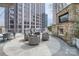 Outdoor patio space with a built-in grill, stone fireplace and comfortable seating at 210 N Church St # 1507, Charlotte, NC 28202