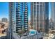 View of a rooftop pool area between condo buildings on a sunny day at 210 N Church St # 1507, Charlotte, NC 28202