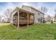 A well-maintained backyard shows a covered deck, a verdant lawn, and a neat exterior at 303 Basswood Ct, Clover, SC 29710