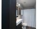 Updated bathroom featuring a dark vanity and a shower and tub combo with a shower curtain at 303 Basswood Ct, Clover, SC 29710