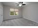 Bedroom with neutral walls, carpeted floor, ceiling fan with light fixture, and a window at 303 Basswood Ct, Clover, SC 29710