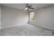 Bedroom with neutral walls, carpeted floor, ceiling fan with light fixture, and a window at 303 Basswood Ct, Clover, SC 29710